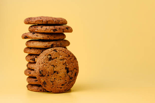 istock Pile of chocolate chip cookies on yellow backgreound 1285339851