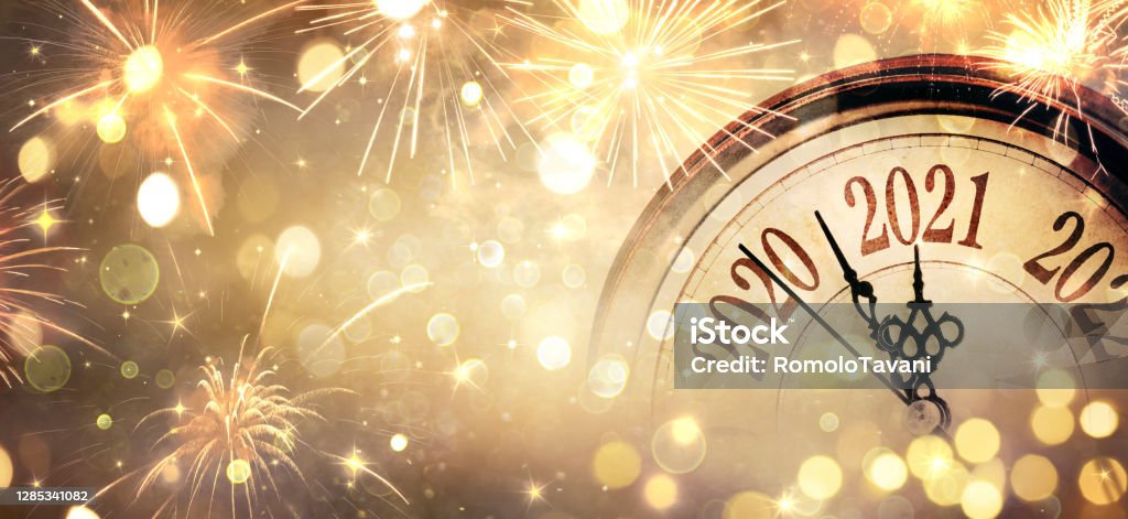 Countdown To Midnight - Happy New Year 2021 - Abstract Defocused Background - Clock And Fireworks Happy New Year 2021 - Countdown To Midnight - Clock And Bokeh Lights New Year's Eve Stock Photo