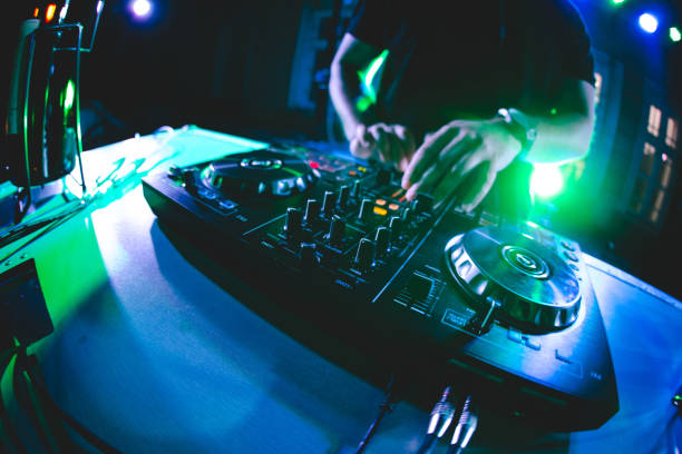 istock DJ playing and mixing music at party 1285342857