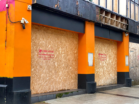 Cardiff, Wales - November 2020: Empty shop boarded up in the shopping centre in Cardiff city centre