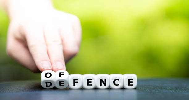 istock Dice form the words offence and defence. 1285343531