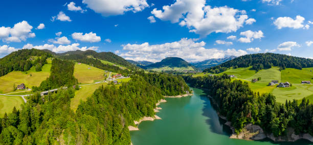 Aerial view of the river Bolgenach with reservoir in Vorarlberg, the most western part of Austria. There is the village Hittisau in the background.