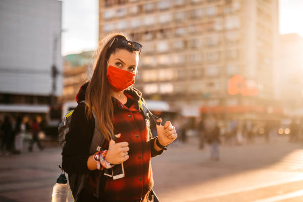 istock Tourist woman with face mask downtown 1285346442