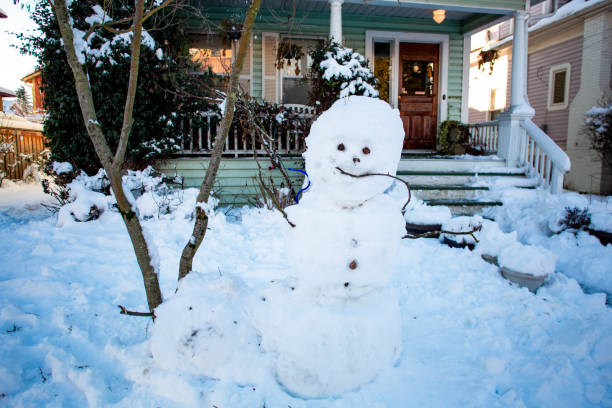 istock Snowman Built In Front Yard of Pacific Northwest Winter home 1285348175