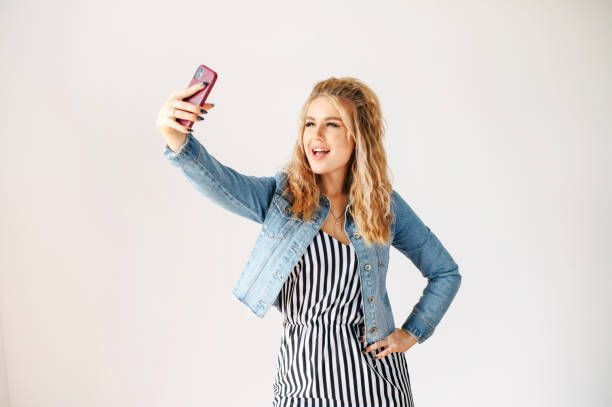 istock Beautiful blonde woman taking a selfie 1285354826
