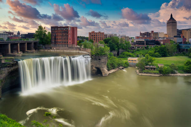 High Falls and city skyline of Rochester, New York High Falls district in Rochester New York under cloudy summer skies finger lakes stock pictures, royalty-free photos & images