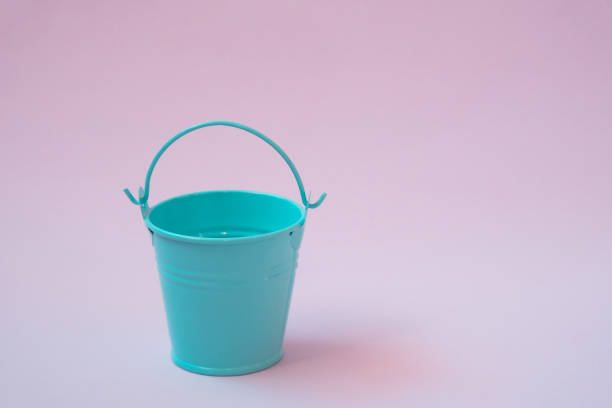 istock Blue mini bucket on a light pink background 1285356050