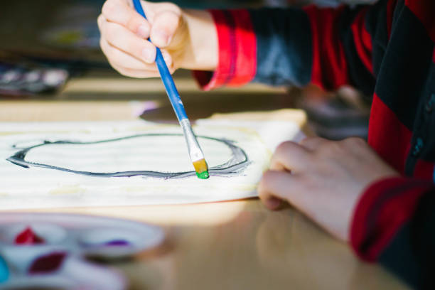 istock the child draws with paints up close 1285357910