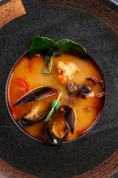 istock Tom Yam soup with mussels on a black background 1285358103