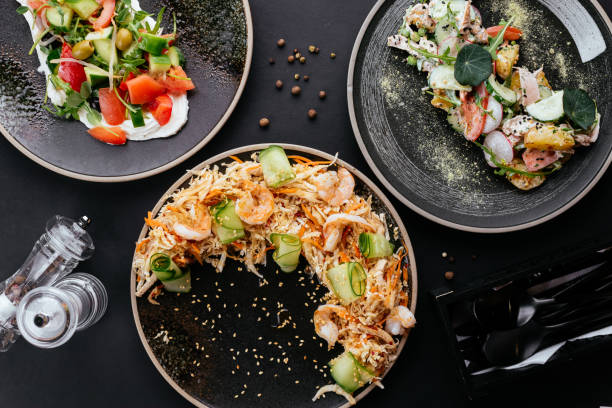 istock Asian vegetable salad with shrimp on a black background 1285358137