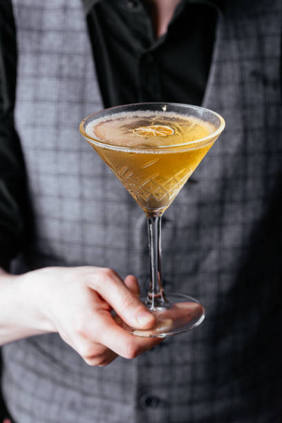 istock yellow citrus cocktail in men's hands 1285358174