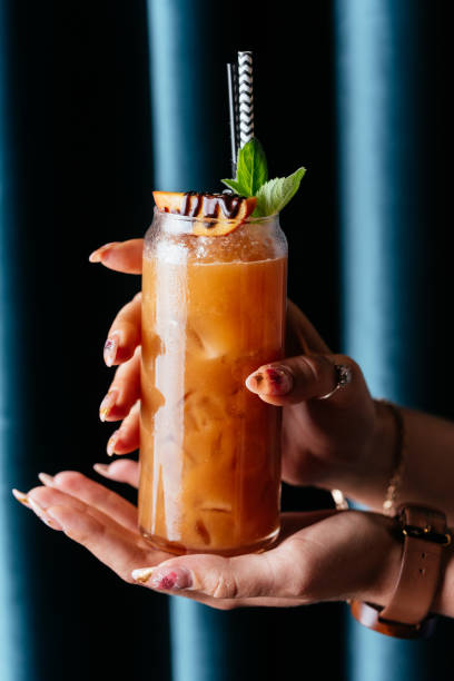 istock yellow citrus cocktail in women's hands 1285358211