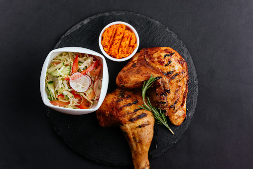 grilled chicken legs with vegetables and sauce in Dubai, Dubai, United Arab Emirates