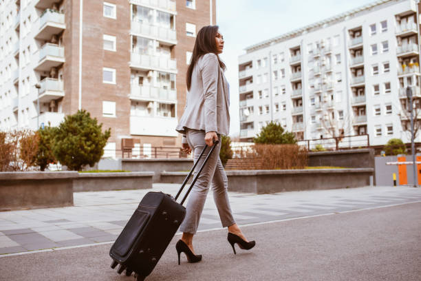 istock Woman using smart phone and waiting for a taxi 1285358675