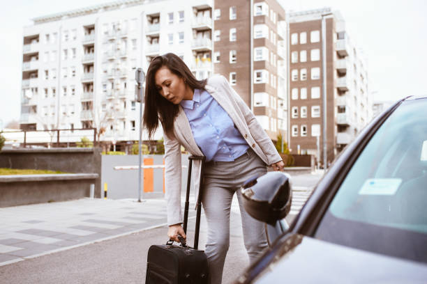 istock Woman using smart phone and waiting for a taxi 1285359213