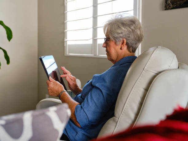 istock Senior Aged Woman Using Technology in Her Home 1285361960