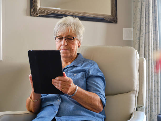 istock Senior Aged Woman Using Technology in Her Home 1285362509