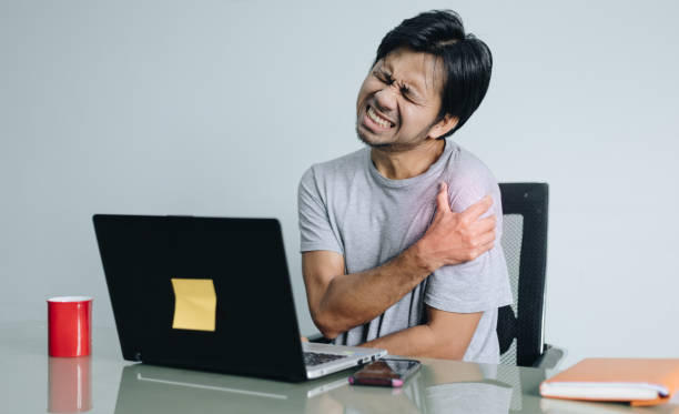 young asian man shoulder pain, office syndrome, health problem concept - physical injury backache occupation working imagens e fotografias de stock