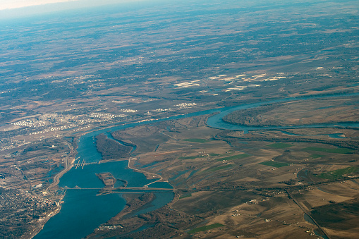 Aerial view of confluence of Mississippi and Missouri Rivers. Mississippi River to left and top with Melvin Price Locks and Dam and Clark Bridge visible oon the Mississippi at left.