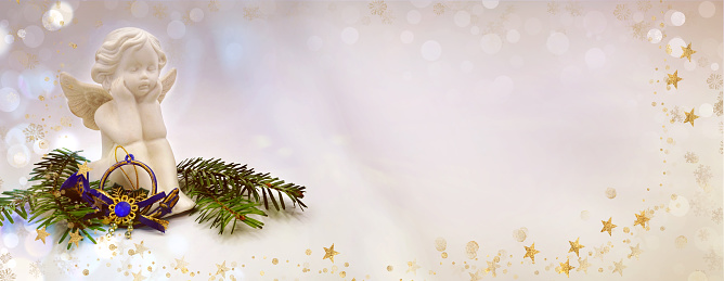 Christmas banner with fir branches and Christmas angel on beige background. Space for text.