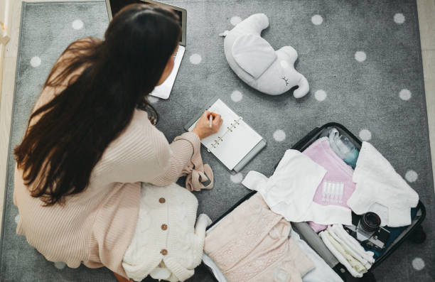 a pregnant woman prepares a bag for the hospital - labour room imagens e fotografias de stock