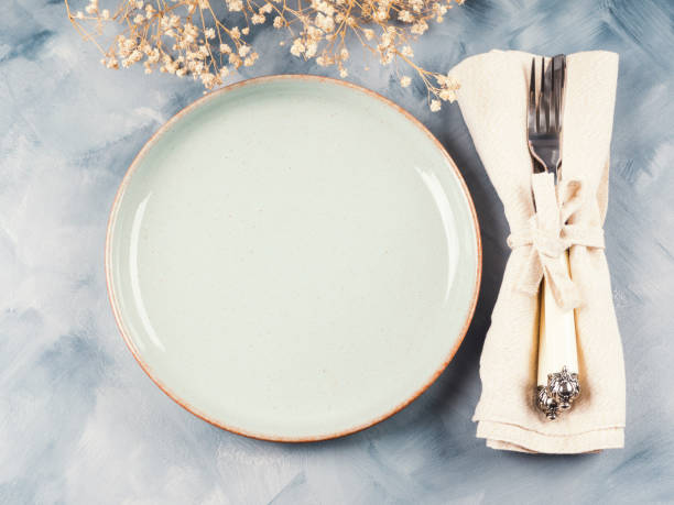 istock Blue pastel dish and silverware with dried flowers 1285374486