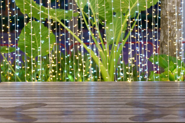 Abstract bokeh from colorful lights at night and wood floor.