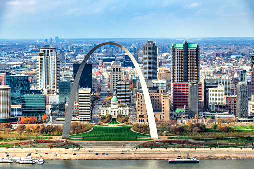 The Gateway to the West Arch and skyline of St. Louis, Missouri along the banks of the mighty Mississippi River shot from an altitude of about 600 feet over the river.