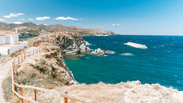 View at mediterranean coastline with transparent sea and small beach town at summer Llanca, Catalonia, Spain. View at mediterranean coastline and small beach town at summer cap de creus stock pictures, royalty-free photos & images