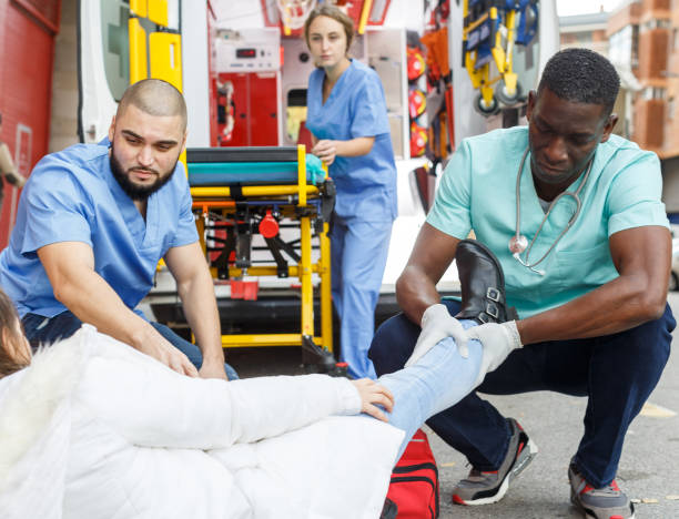 istock Ambulance team helping injured woman 1285378520