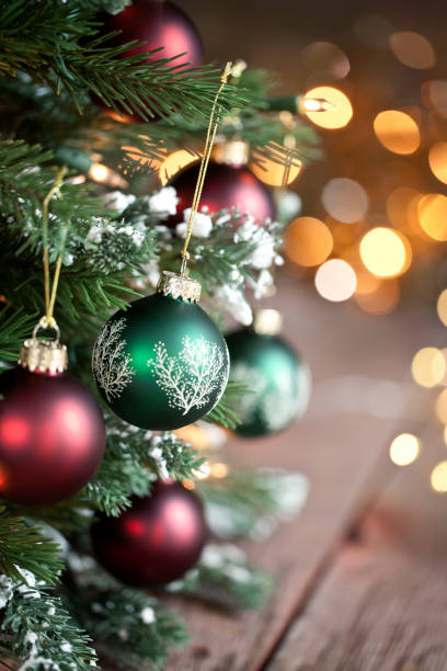 istock Christmas Tree, Red and Green Ornaments against a Defocused Lights Background 1285381974