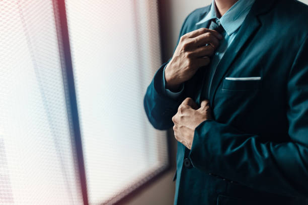 istock Businessman ware suit and adjusting necktie. 1285383085