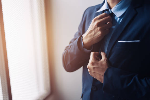 istock Businessman ware suit and adjusting necktie. 1285383091