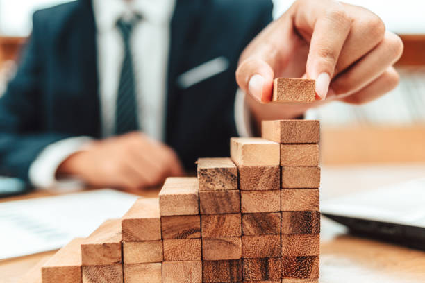 istock Ant eye view Male hand stacking wooden blocks. Business development and growth concept 1285383359
