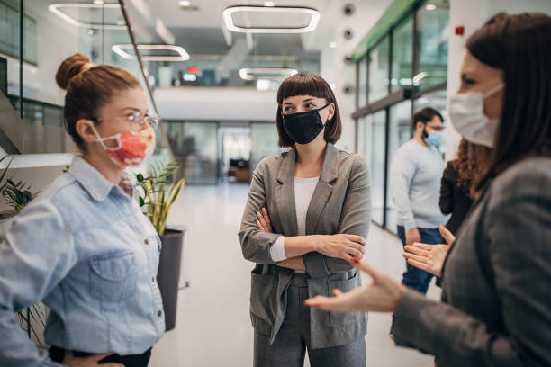 istock Women talking in modern firm building lobby 1285385196