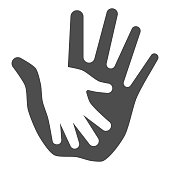istock Palm of child in adult solid icon, kids protection concept, helping hand sign on white background, child protection by parents or volunteers icon in glyph style. Vector graphics. 1285387549