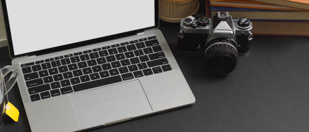 istock Worktable with laptop, camera, books and copy space in home office, clipping path 1285387689