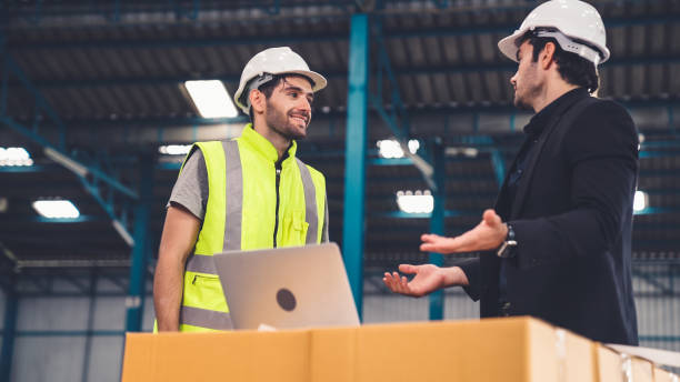istock Two factory workers working and discussing manufacturing plan in the factory . 1285389520