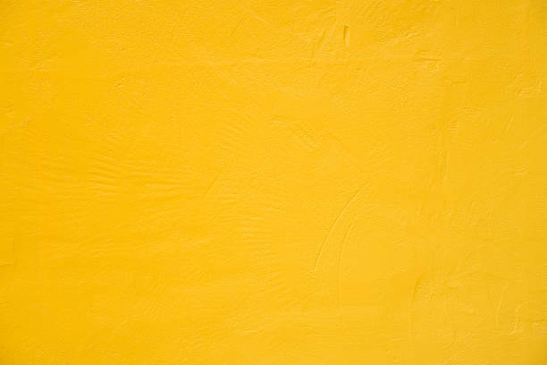 istock Yellow concrete texture details background. Paint brickwork wall and copy space. 1285389561