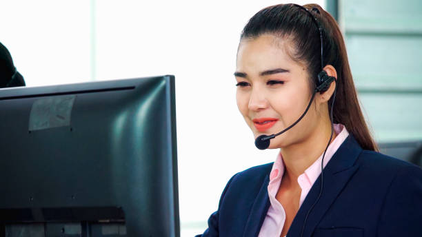 istock Business people wearing headset working in office 1285391065