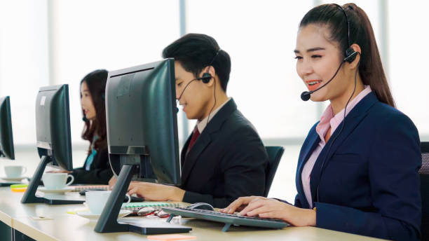 istock Business people wearing headset working in office 1285392020