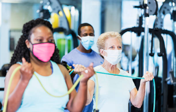 istock Exercise class in gym, wearing face masks 1285392025