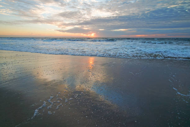 istock Tranquility scene, beautiful tropical beach sunset in light pink and blue colors with beautiful sun reflection on the beach 1285392126
