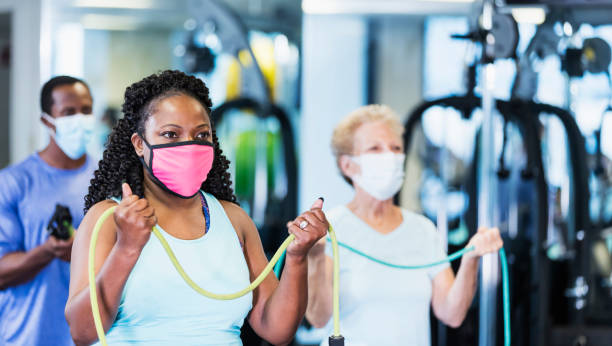 istock Exercise class in gym, wearing face masks 1285392142