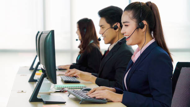 istock Business people wearing headset working in office 1285392214
