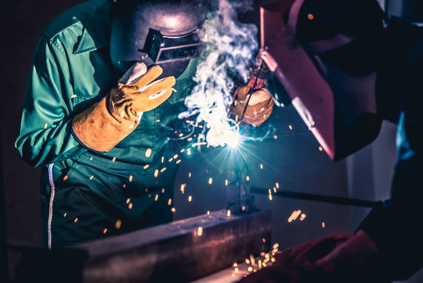 istock Metal welding steel works using electric arc welding machine 1285395043
