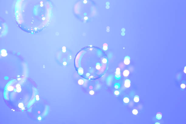 istock Beautiful shiny bokeh blur soap bubbles float on purple texture background. Abstract, Celebration, Natual fresh summer, Chrimas holiday background. 1285395758