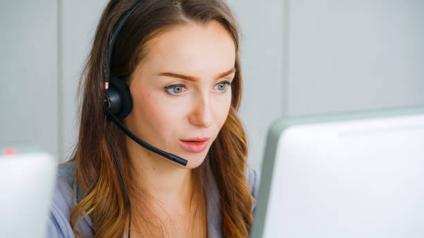 istock Business people wearing headset working in office 1285395782
