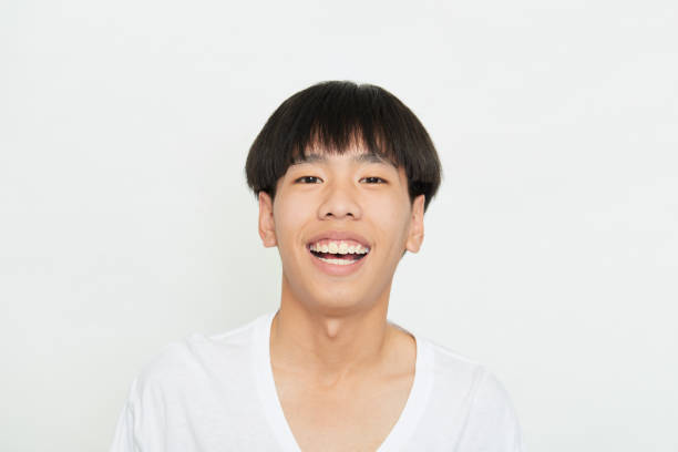 istock Close up portrait Young Man Smiling Happy on white 1285396530
