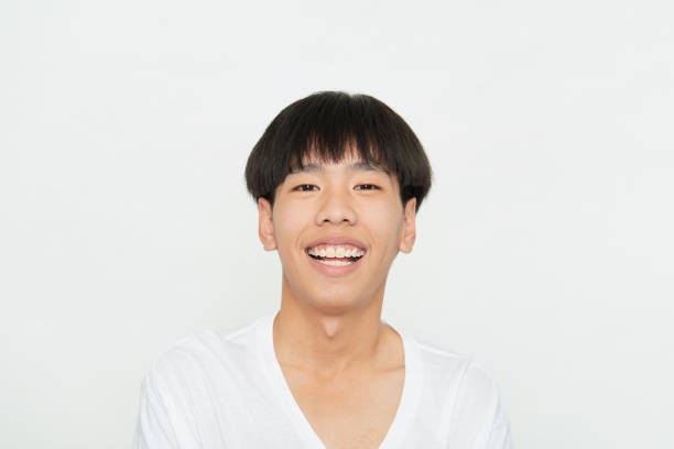 istock Close up portrait Young Man Smiling Happy on white 1285396533